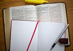 Open Bible and pen and paper